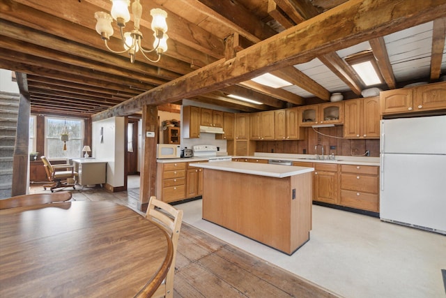 kitchen featuring white appliances, sink, beamed ceiling, a chandelier, and a center island