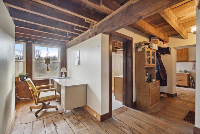 interior space featuring beam ceiling, hardwood / wood-style floors, and wood ceiling