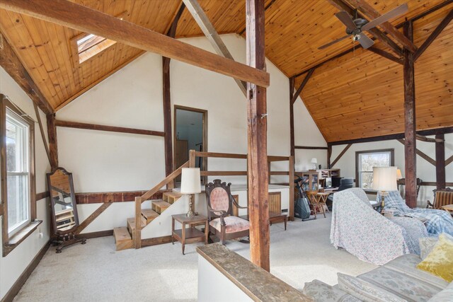 unfurnished bedroom with carpet, beam ceiling, wooden ceiling, and a skylight