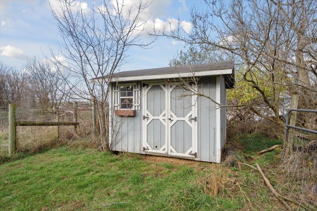 view of outbuilding featuring a lawn