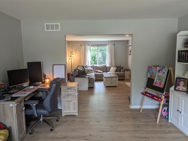 office with light wood-type flooring