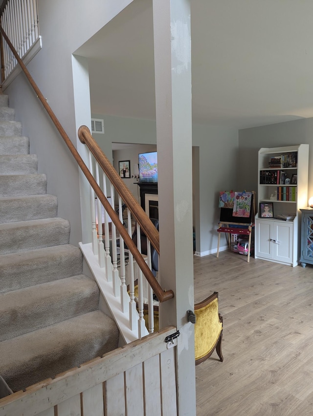 staircase featuring wood-type flooring