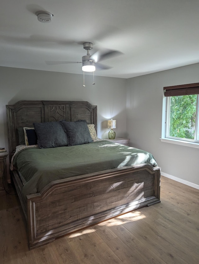 bedroom featuring hardwood / wood-style floors and ceiling fan