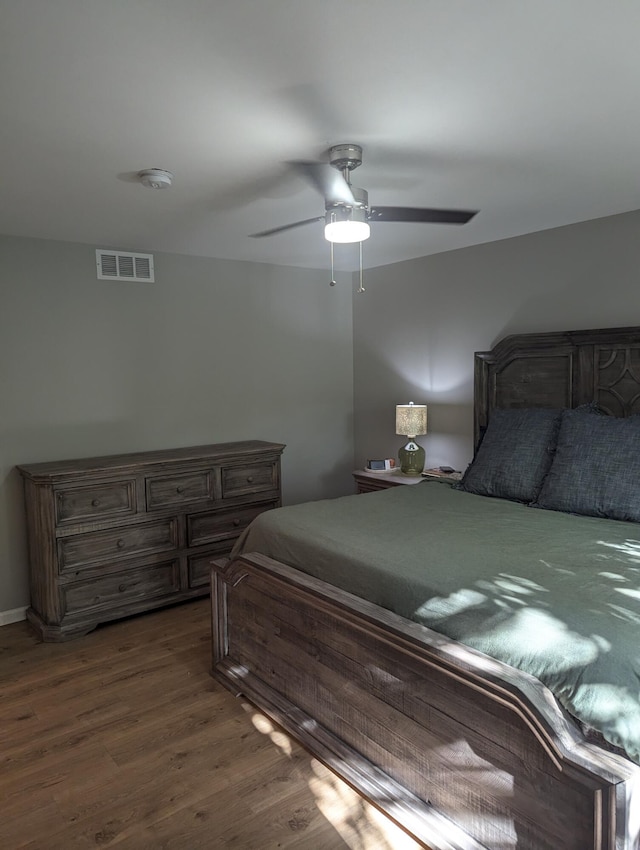 bedroom with ceiling fan and dark hardwood / wood-style floors