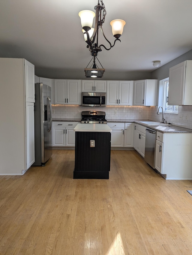 kitchen with white cabinetry, a center island, and stainless steel appliances