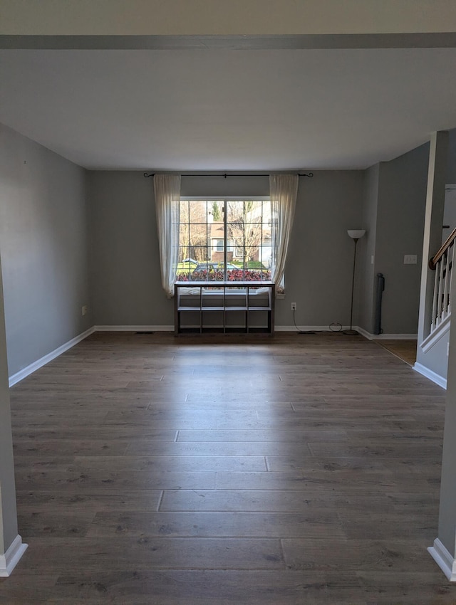 unfurnished room with dark hardwood / wood-style flooring