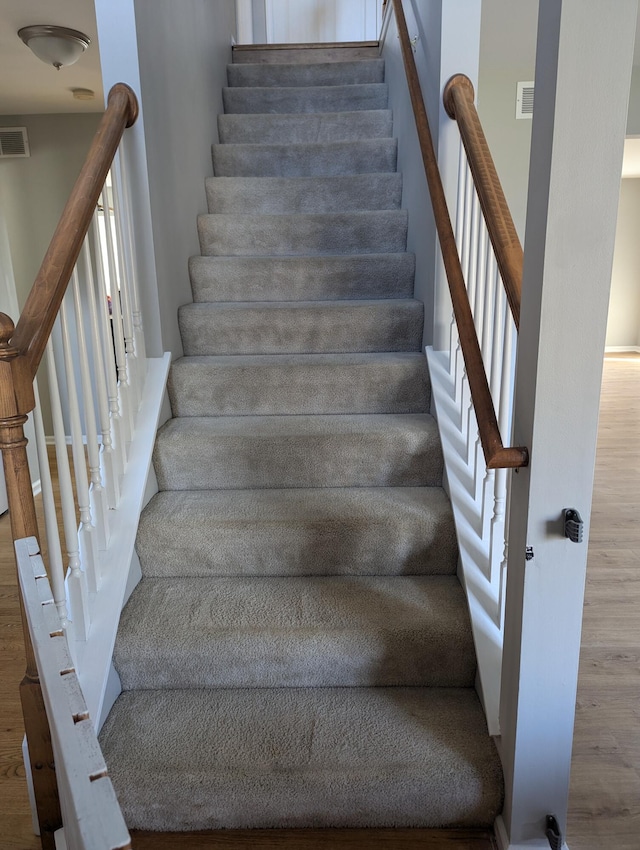 staircase with wood-type flooring