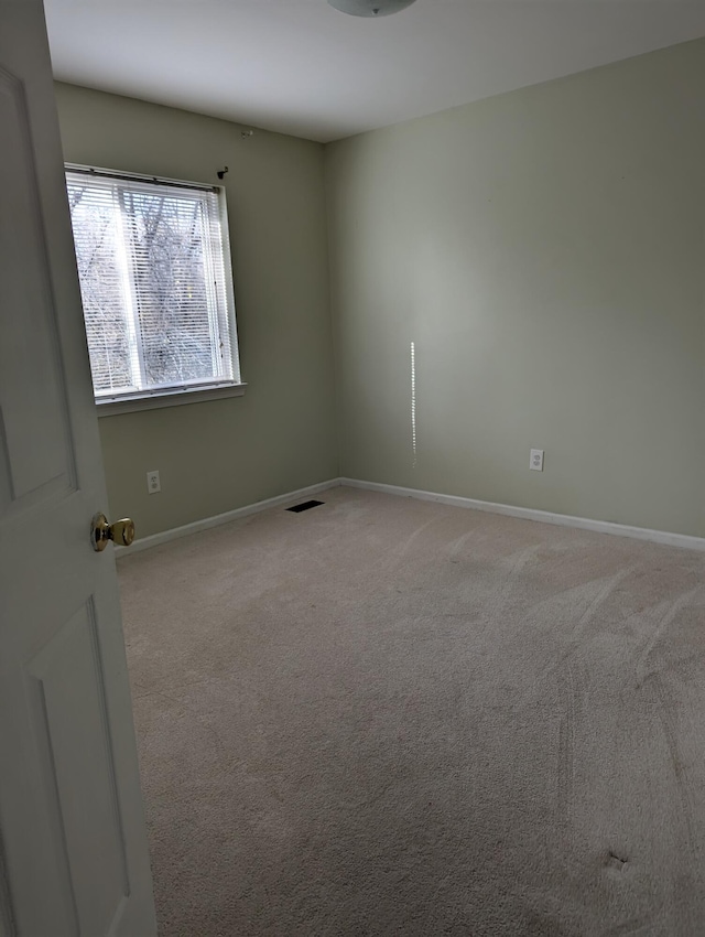 empty room featuring light carpet