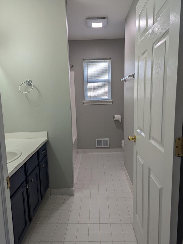 bathroom with tile patterned flooring, vanity, and toilet