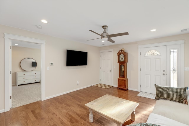 unfurnished living room featuring ceiling fan and light wood-type flooring