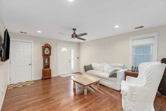 living room with hardwood / wood-style flooring and ceiling fan