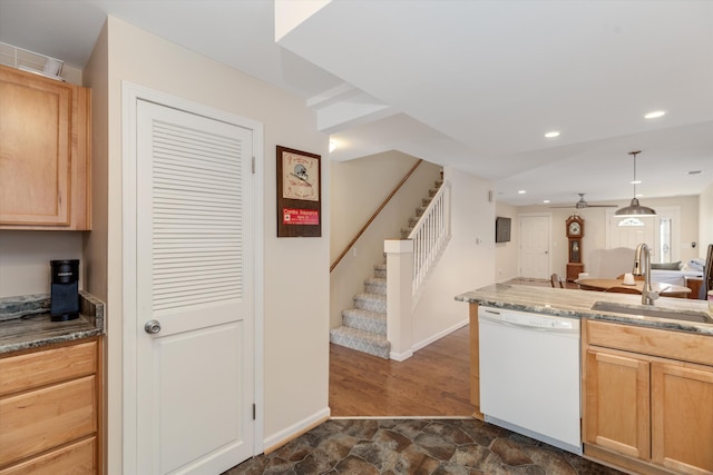 kitchen featuring dishwasher, light brown cabinets, dark wood-type flooring, sink, and pendant lighting