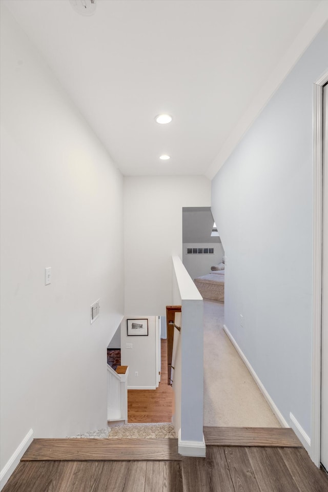 staircase with wood-type flooring