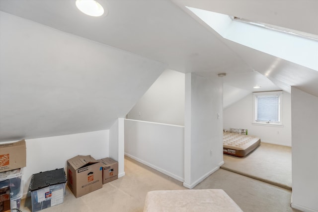 additional living space featuring light carpet and lofted ceiling