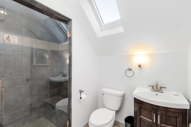 bathroom featuring toilet, vanity, lofted ceiling with skylight, and a shower with shower door