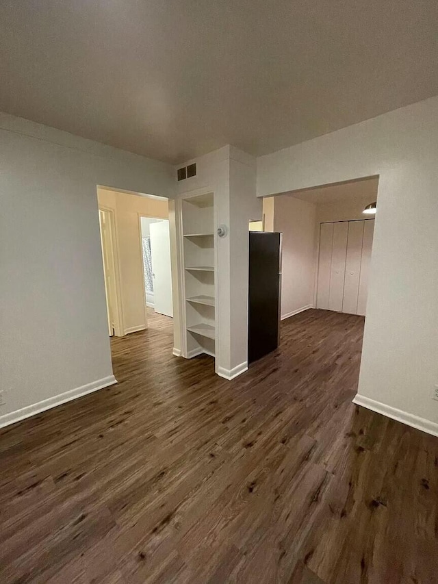 unfurnished living room with dark hardwood / wood-style floors