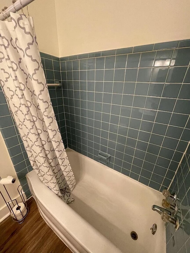 bathroom featuring shower / bath combo with shower curtain and wood-type flooring