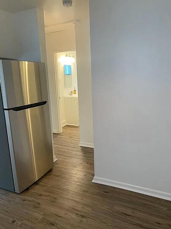 kitchen featuring stainless steel refrigerator and dark wood-type flooring