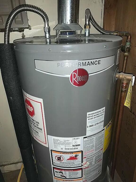 utility room featuring water heater