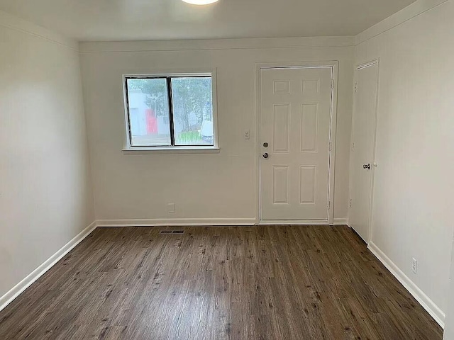 empty room with dark hardwood / wood-style floors