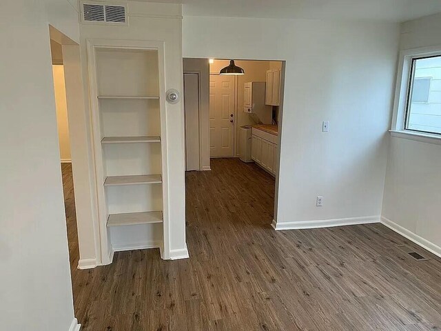 corridor featuring dark hardwood / wood-style floors