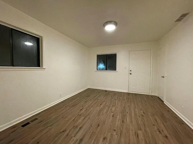 unfurnished room featuring dark wood-type flooring