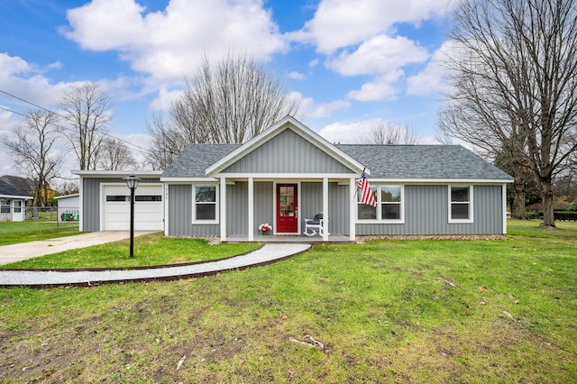 view of front of property featuring a garage, covered porch, and a front yard