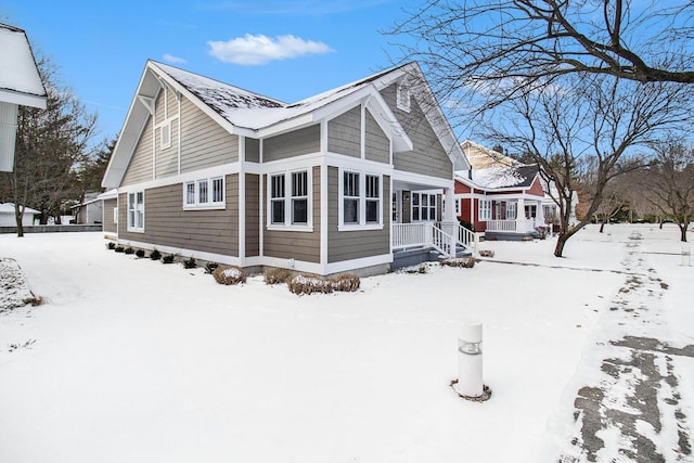 view of snow covered rear of property