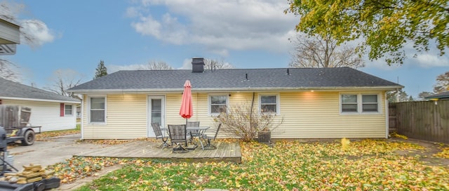 rear view of house featuring a wooden deck