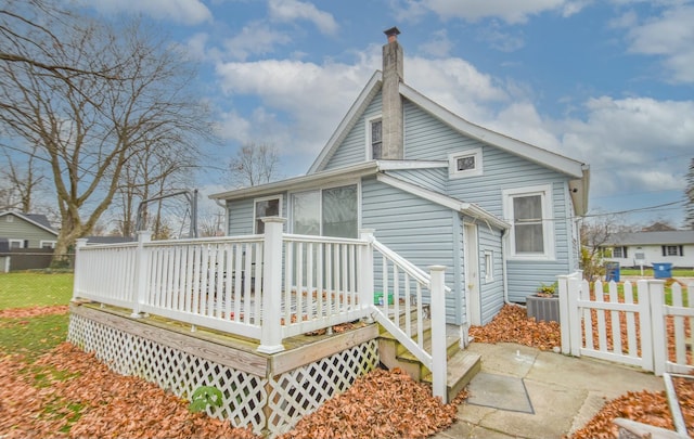 back of property featuring a wooden deck