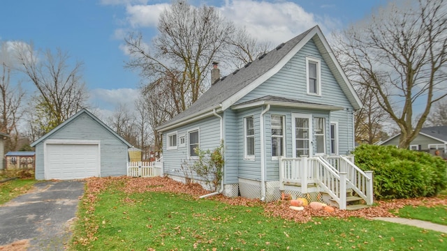 view of front of home with a garage, an outdoor structure, and a front yard