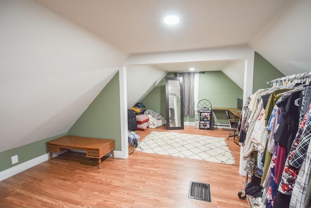 interior space featuring hardwood / wood-style floors and vaulted ceiling