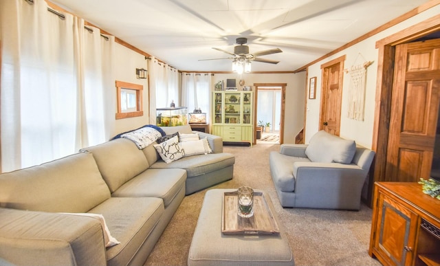 living room featuring ceiling fan, light colored carpet, and ornamental molding