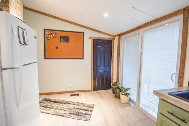 interior space with hardwood / wood-style flooring, lofted ceiling, and sink