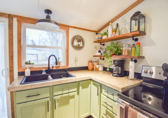 kitchen featuring sink, ornamental molding, pendant lighting, stainless steel range with electric stovetop, and green cabinetry