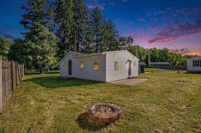 yard at dusk with a fire pit