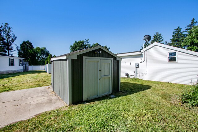 view of outbuilding featuring a lawn