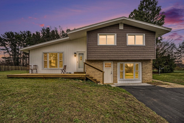 view of front of home featuring a yard and a deck