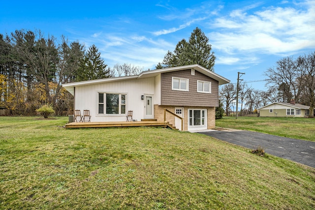 view of front facade with a front yard and a deck