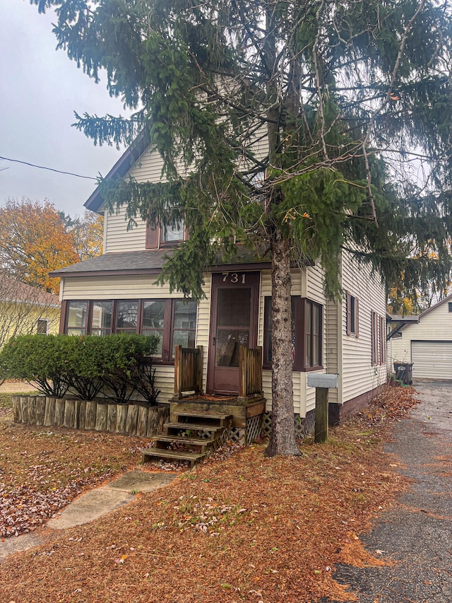 view of front of property with a garage and an outdoor structure