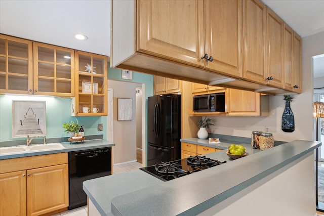 kitchen featuring light tile patterned flooring, sink, light brown cabinetry, and black appliances