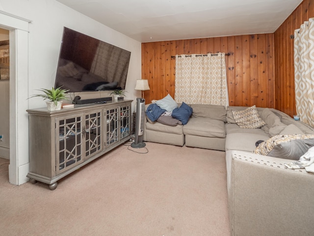 living room with carpet flooring and wood walls