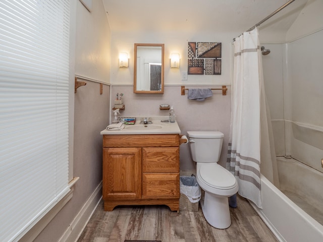 full bathroom with vanity, toilet, wood-type flooring, and shower / tub combo