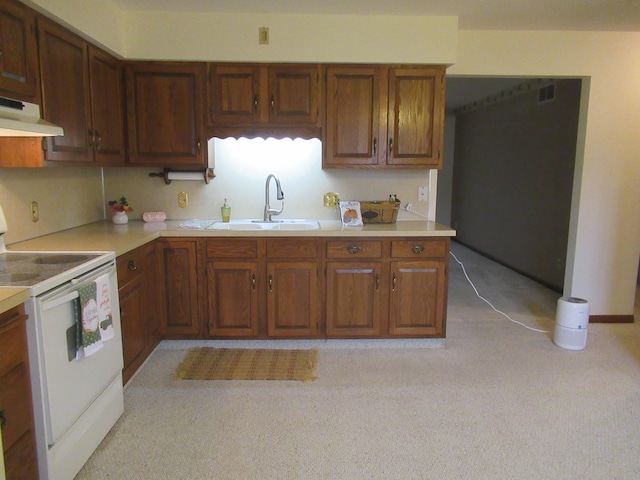 kitchen with light carpet, white electric range, and sink