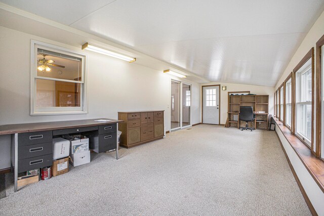 interior space featuring ceiling fan, light colored carpet, and lofted ceiling