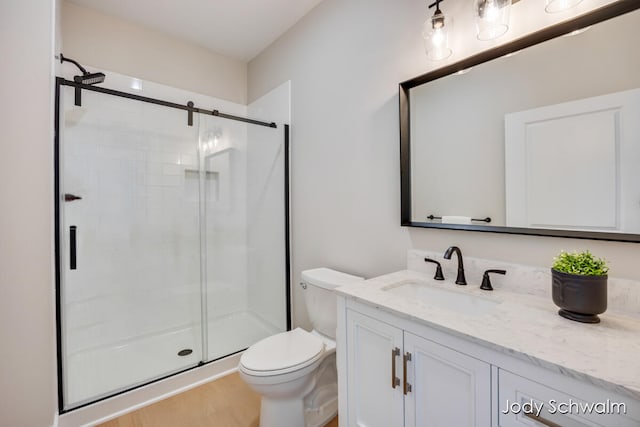 bathroom featuring hardwood / wood-style floors, vanity, toilet, and walk in shower