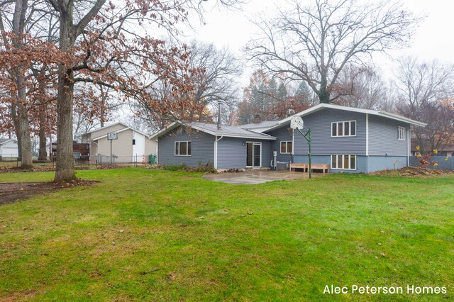 rear view of house featuring a patio area and a yard