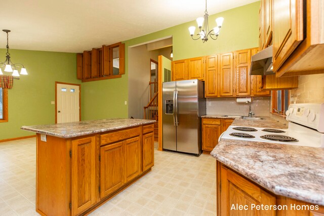 kitchen featuring white range with electric stovetop, hanging light fixtures, stainless steel refrigerator with ice dispenser, range hood, and a notable chandelier