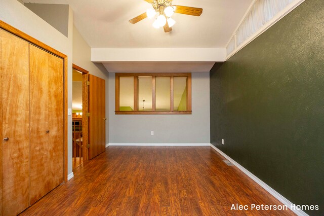 unfurnished room with ceiling fan and dark hardwood / wood-style flooring