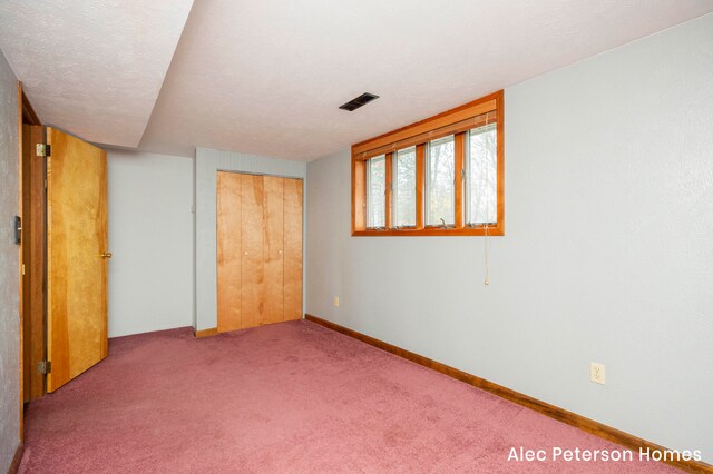 interior space with carpet flooring and a textured ceiling